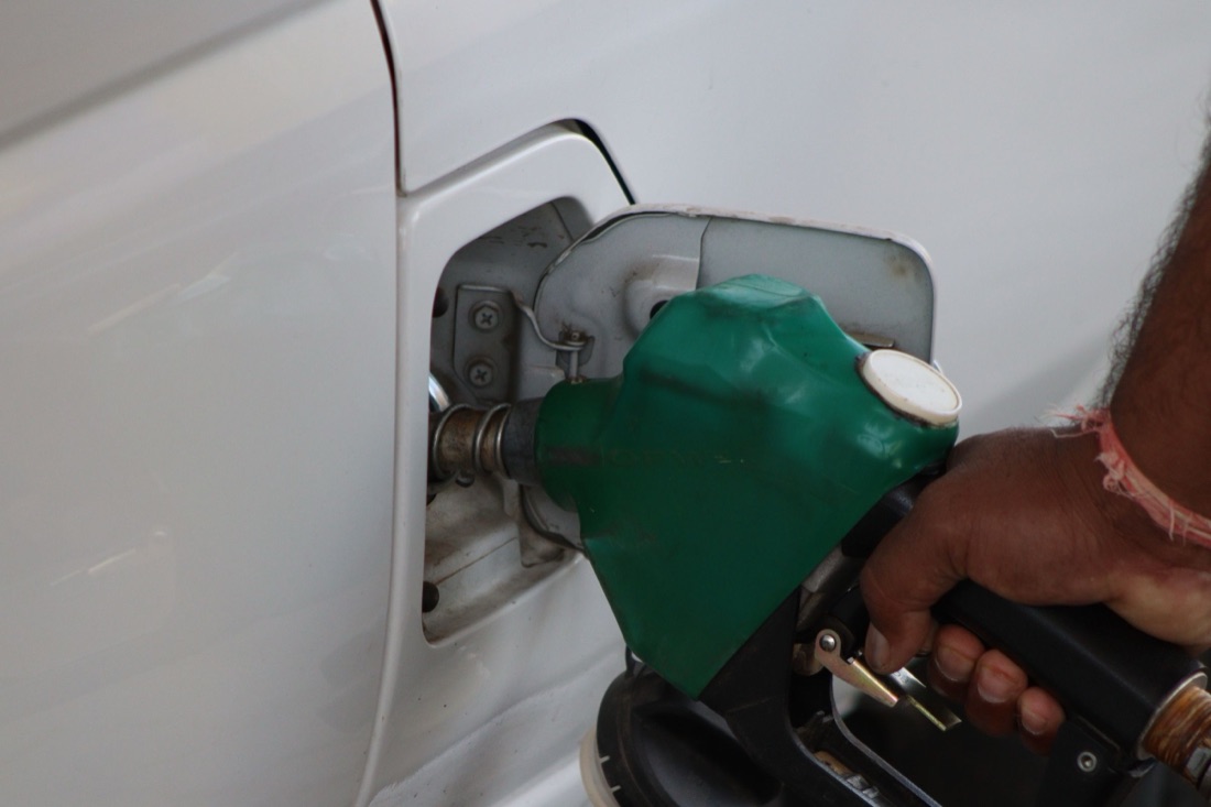A vehicle refueling at a gas station forecourt
